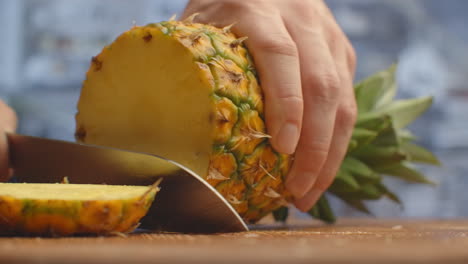 Pineapple-close-up-cut-on-a-wooden-board.-shred.